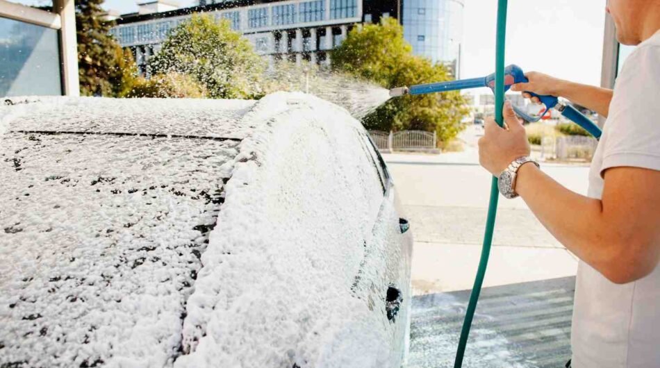 man-using-hose-clean-his-car-1