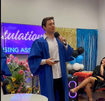 a-man-in-a-blue-robe-holding-a-microphone