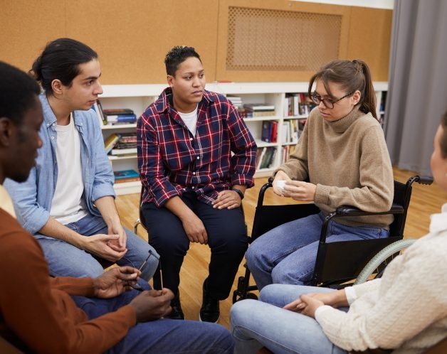 disabled-woman-crying-in-support-group-r9xtnv5ap13e1vo0zhn8e4pm4i2456ll2rbaf6kub8