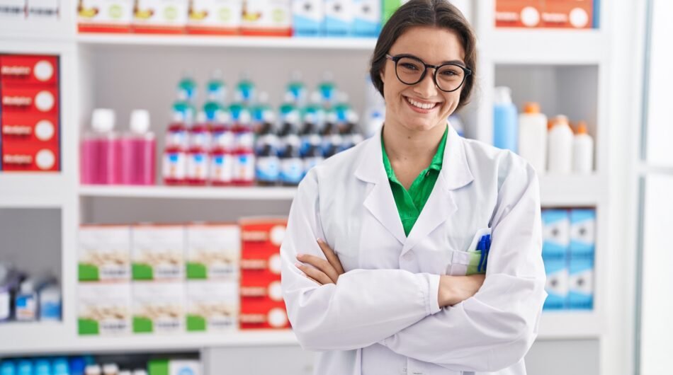 young-hispanic-woman-pharmacist-smiling-confident-standing-with-arms-crossed-gesture-pharmacy