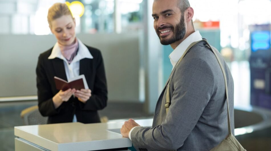 smiling-commuter-standing-counter-while-attendant-checking-his-passport-1536×1024-1