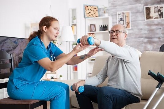 imgi_1_senior-man-nursing-home-with-doing-physical-therapy-with-help-from-nurse-using-dumbbells_j-1