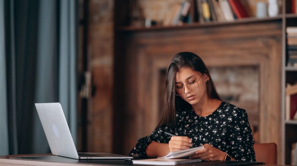 beautiful-business-woman-writing-something-notebook