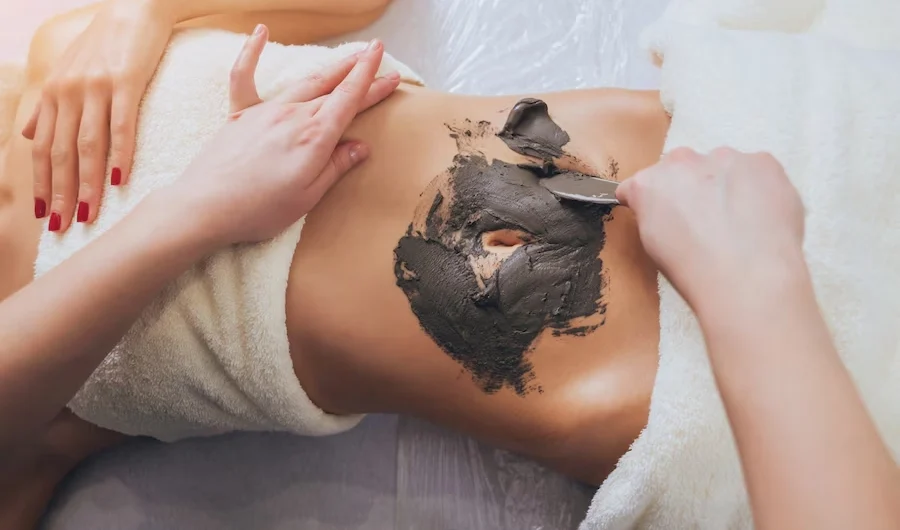 beautiful-woman-spa-salon-getting-mud-body-massage_179755-3610-1