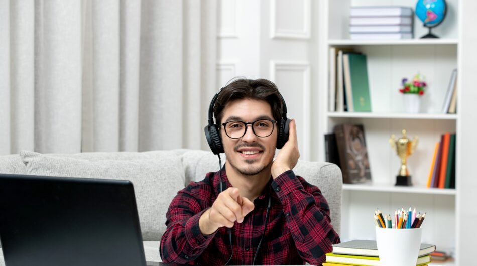 student-online-young-guy-checked-shirt-with-glasses-studying-computer-pointing-front